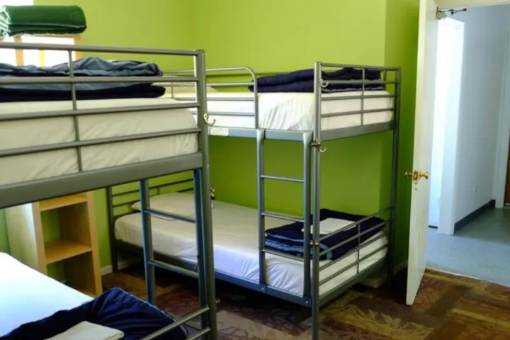 a bedroom with a bed and desk in a room