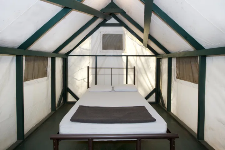 a bedroom with a building in the background