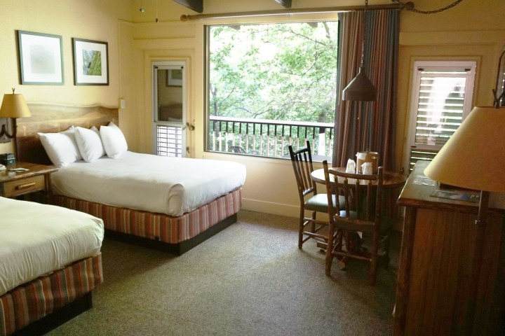 a bedroom with a bed and desk in a hotel room