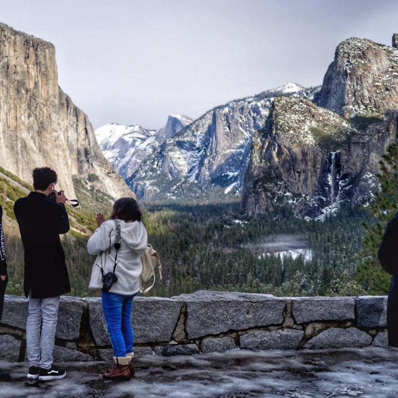 a group of people standing on top of a mountain