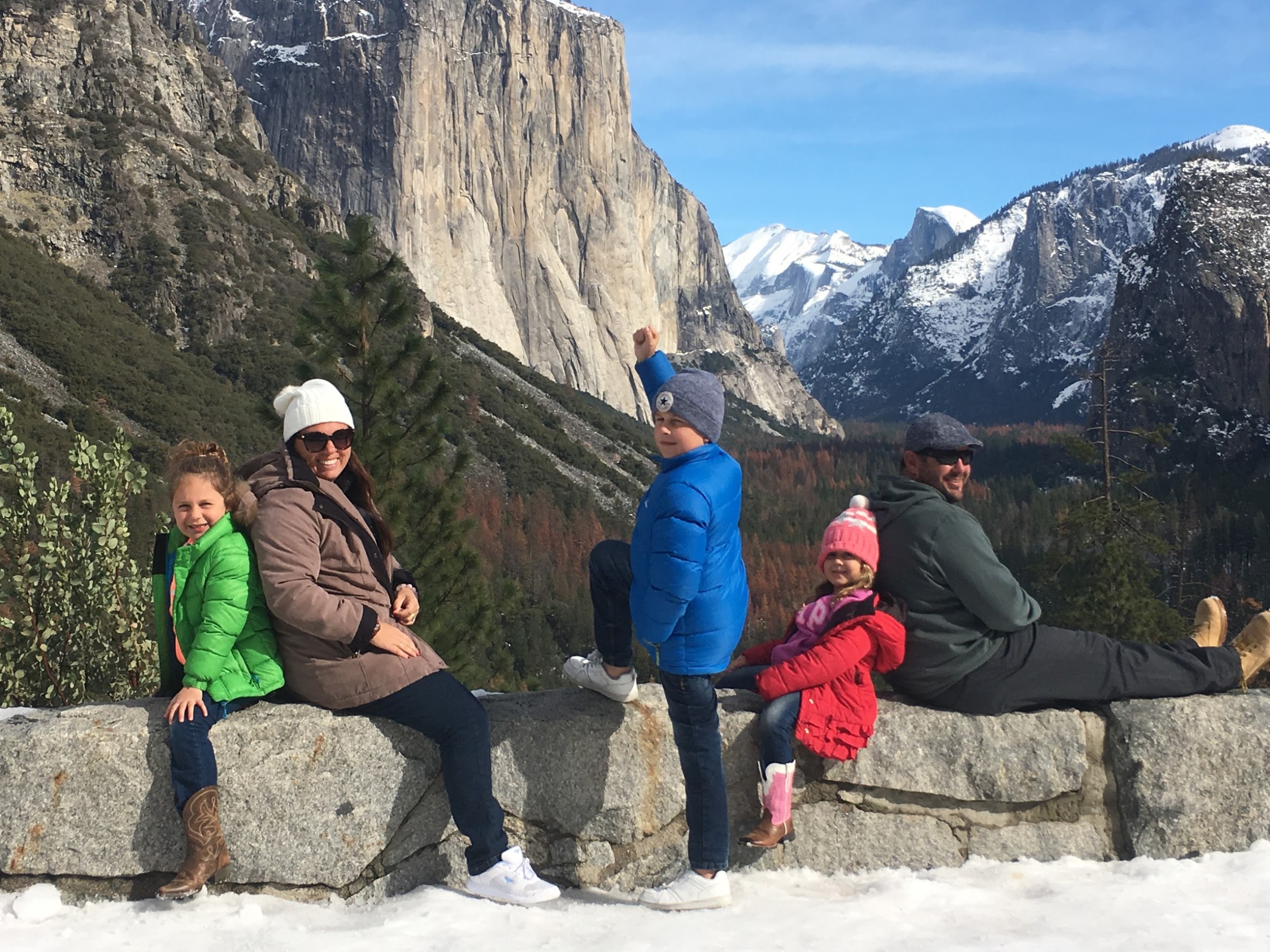 a group of people sitting on a rock