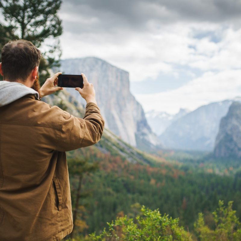 a man standing in front of a mountain