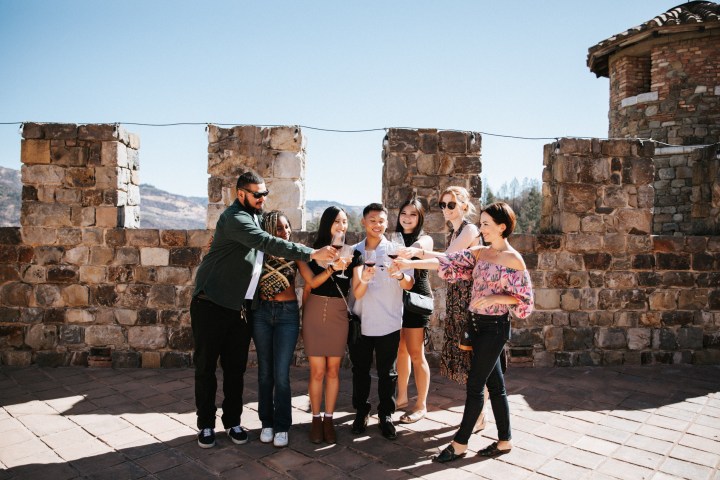 a group of people standing in front of a brick building