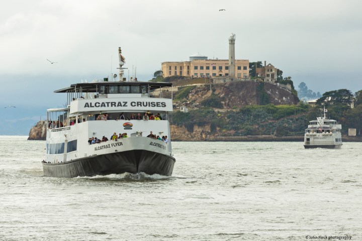 a large ship in a body of water with Alcatraz Island in the background