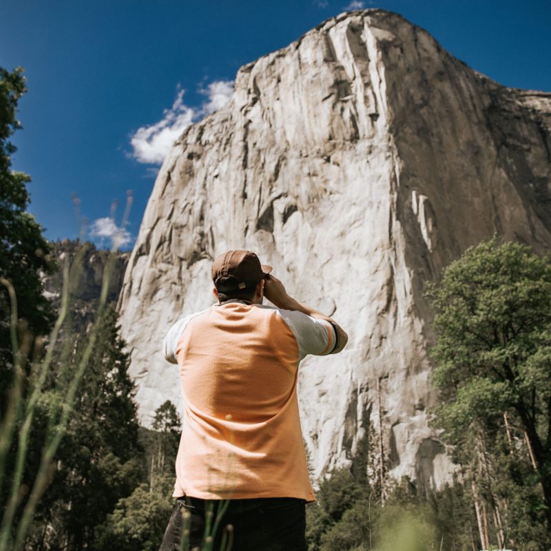 a person standing in front of a mountain